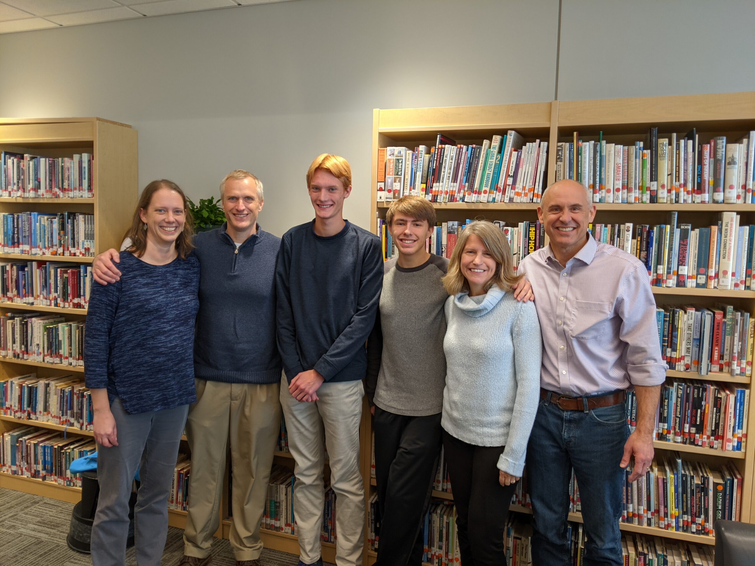 Nathan Romine and Justin Vos pose with their parents at the Whitinsville Christian School Library and Media Center 